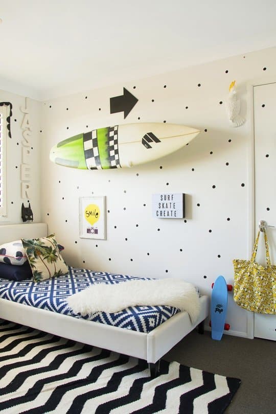 This eclectic kids room is fabulous! I can't get enough of that wall!