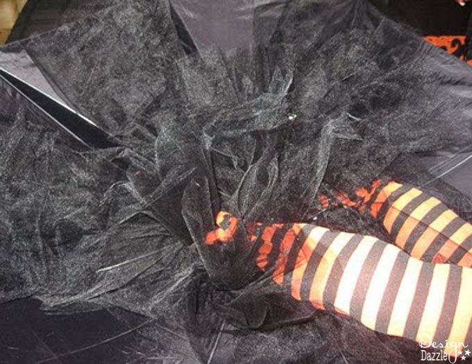These adorable striped whimsical witch legs hang from the ceiling to make an adorable centerpiece for any Halloween Party! | Design Dazzle These adorable striped whimsical witch legs hang from the ceiling to make an adorable centerpiece for any Halloween Party! | Design Dazzle