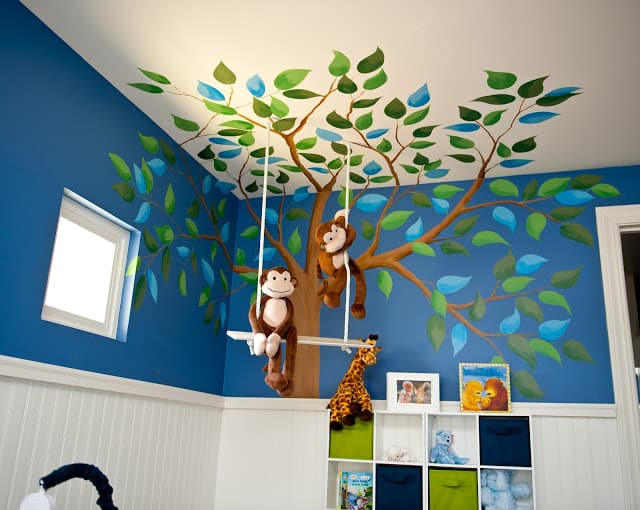 Adorable Monkey Business Nursery by Sue Vlautin of Red Geranium Interiors! Vibrant colors with cool wall murals and monkeys hanging from the ceiling!! 
