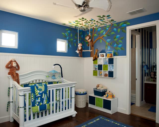 Adorable Monkey Business Nursery by Sue Vlautin of Red Geranium Interiors! Vibrant colors with cool wall murals and monkeys hanging from the ceiling!! 