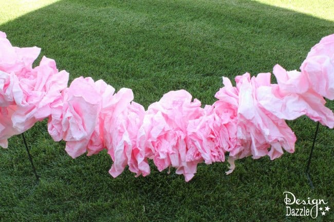 DIY a fabulous paper ruffle garland from a roll of paper towel!! A simple, quick detail that will make all the difference! Tutorial on design dazzle.com! #DIYfairyparty #DIYpartydecor #papertowelgarland