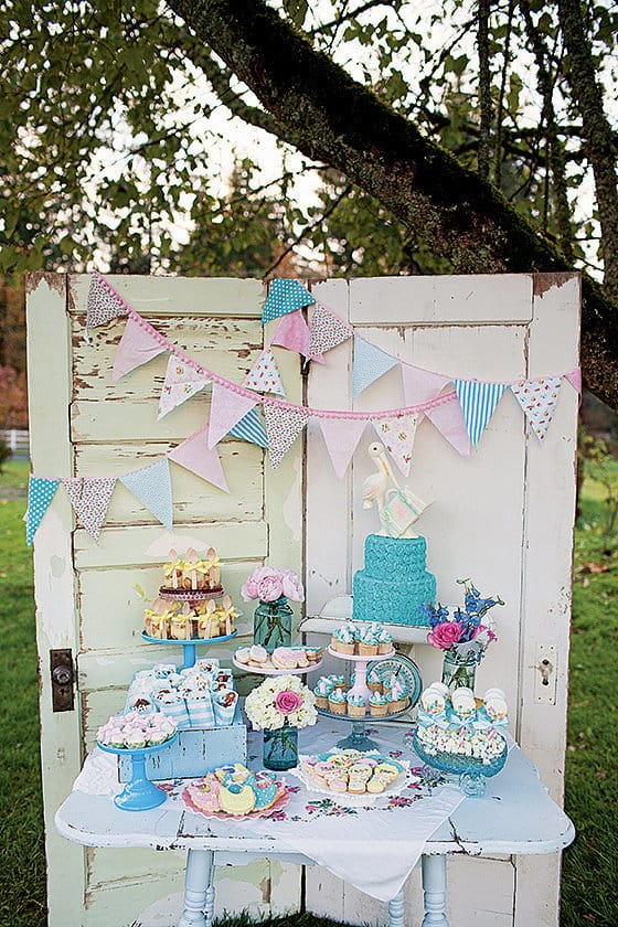 Vintage stork themed baby shower dessert table setup