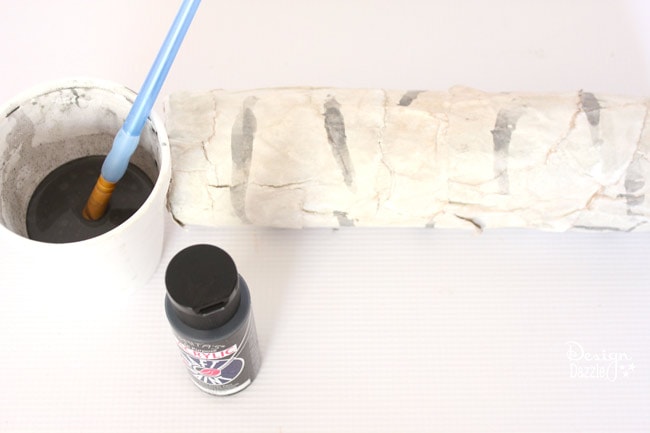 Step-by-step tutorial of how to make pool noodles into faux birch logs on Designdazzle.com. #diyChristmasdecor #poolnoodlediy