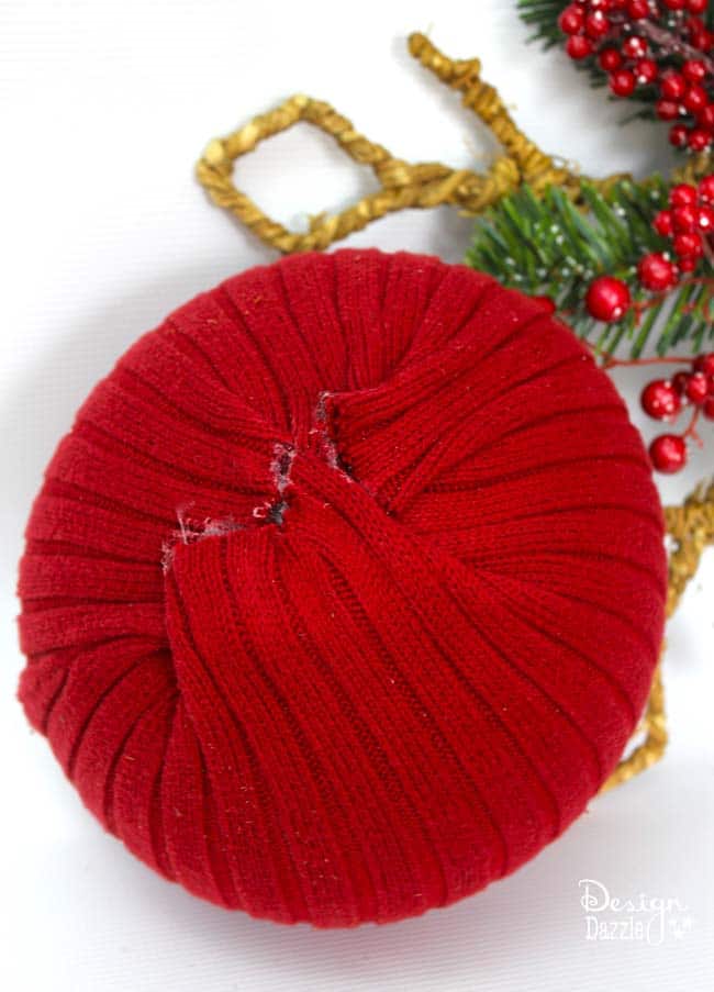 Repurpose Sweaters Into Oversized Ornaments. Old knit sweaters and a glue gun create beautiful Christmas ornaments. Use a dollar store ball as the form - much cheaper than styrofoam. Design Dazzle #christmas #christmascrafts #repurposedsweaters