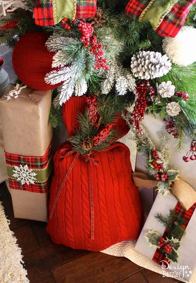 Repurpose an old sweater into a gift bag. Love the warm cozy look this sweater brings to our Christmas decor. Reuse it every year to wrap gifts. Use the glue gun or sew it! Design Dazzle #repurposed