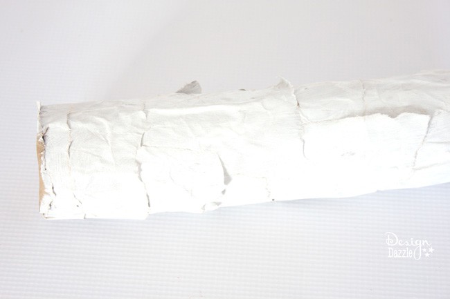 This was once a pool noodle! Tutorial of how to make a faux birch log from a pool noodle at Decigndazzle.com #diyChristmas #poolnoodledecor