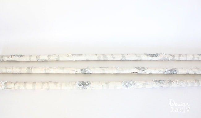 Step-by-step tutorial of how to make pool noodles into faux birch logs on Designdazzle.com. #diyChristmasdecor #poolnoodlediy