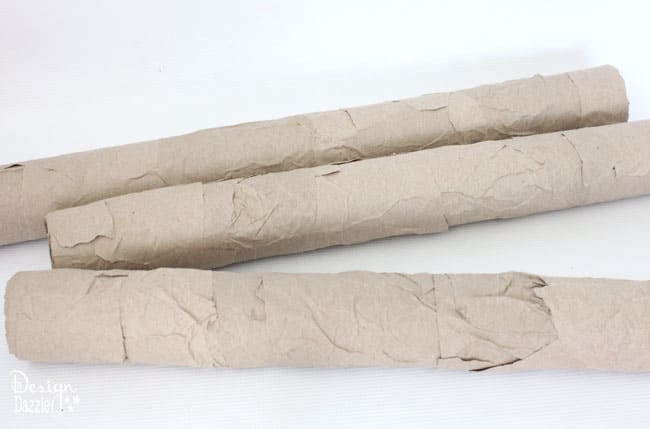 Step-by-step tutorial of how to make pool noodles into faux birch logs on Designdazzle.com. #diyChristmasdecor #poolnoodlediy