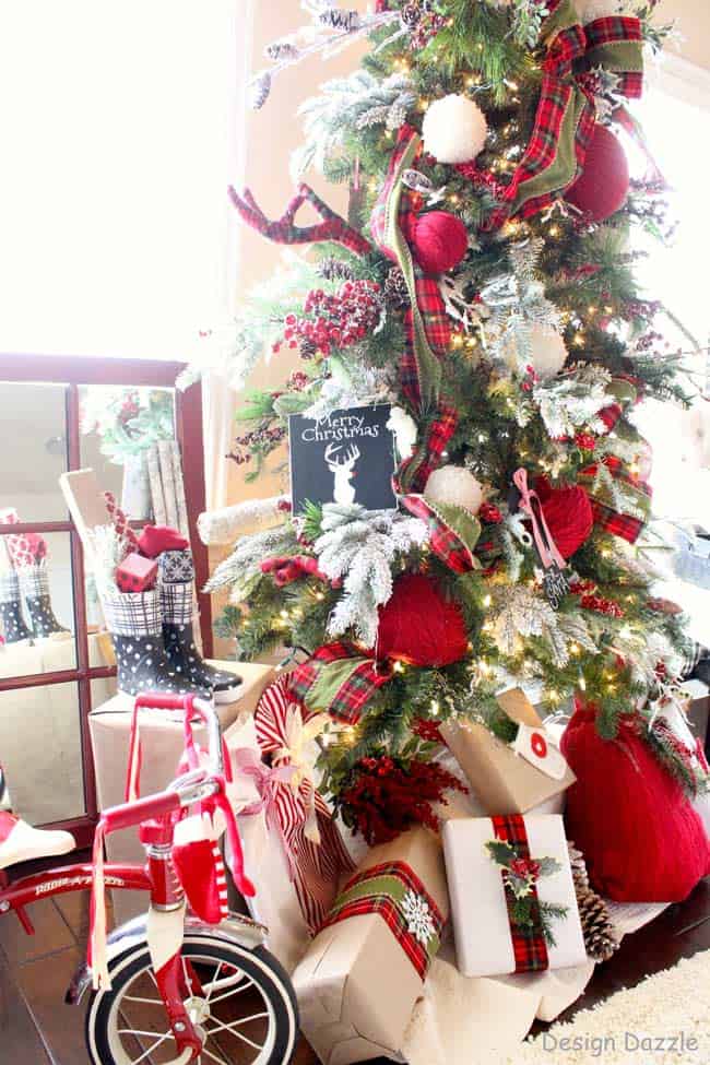 Decorating the tree and living room with plaid, red sweaters upcycled ornaments, and sweater bags. Touch of black and white with a deer topper.