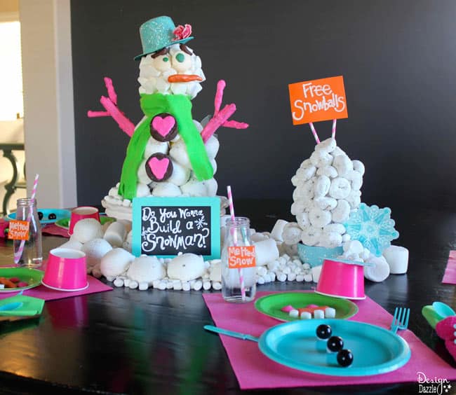 Edible Snowman Centerpiece with Snowman place settings. Edible Snowman Centerpiece made with Hostess Sno Balls, Ding Dongs and Donettes by Design Dazzle #HostessHoliday