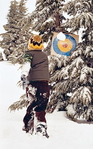 Target practice with snowballs is a great outdoor winter activity for kids!