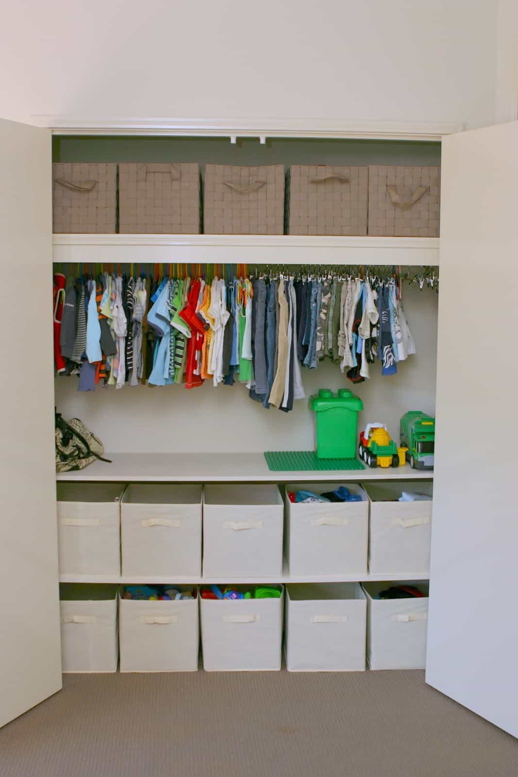 I love all of this storage space! By installing shelves, there is so much more room to store toys and such in bins. See more on Design Dazzle!