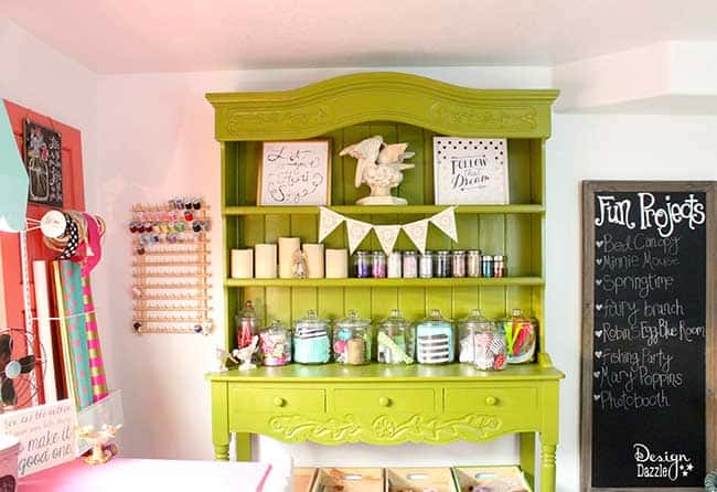 There is nothing I love better than to store my crafts and whatever in unique containers. Sharing a few ideas on unusual containers for the craft room. I'm giving you a full tour of my craft room! Check out the details of my happy place on Design Dazzle.