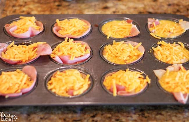 Looking for delicious and easy breakfast ideas? You'll love these ham, egg, and cheese muffin cups! Recipe on Design Dazzle.