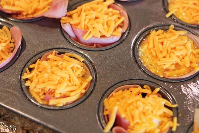 Looking for delicious and easy breakfast ideas? You'll love these ham, egg, and cheese muffin cups! Recipe on Design Dazzle.