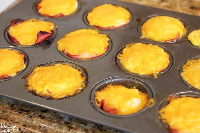 Looking for easy breakfast ideas? You'll love these ham, egg, and cheese muffin cups! Recipe on Design Dazzle.