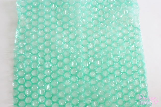 Green bubblewrap for DIY jellyfish costume. DIY Jellyfish Halloween Costume that lights up. Easy no-sew tutorial to create a darling and super fun halloween costume. Shared on Design Dazzle
