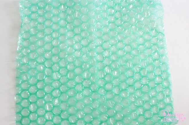 Green bubblewrap for DIY jellyfish costume. DIY Jellyfish Halloween Costume that lights up. Easy no-sew tutorial to create a darling and super fun halloween costume. Shared on Design Dazzle