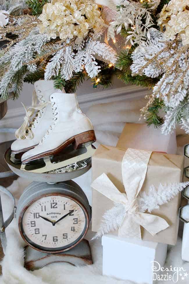 Ice skates under the tree. Winter Wonderland Glam Christmas Tree designed by Toni Roberts of Design Dazzle. Snow tipped branches, gold hydrangeas, white roses, lots of bling and touches of galvanized metal create this Winter Wonderland Glam Tree.