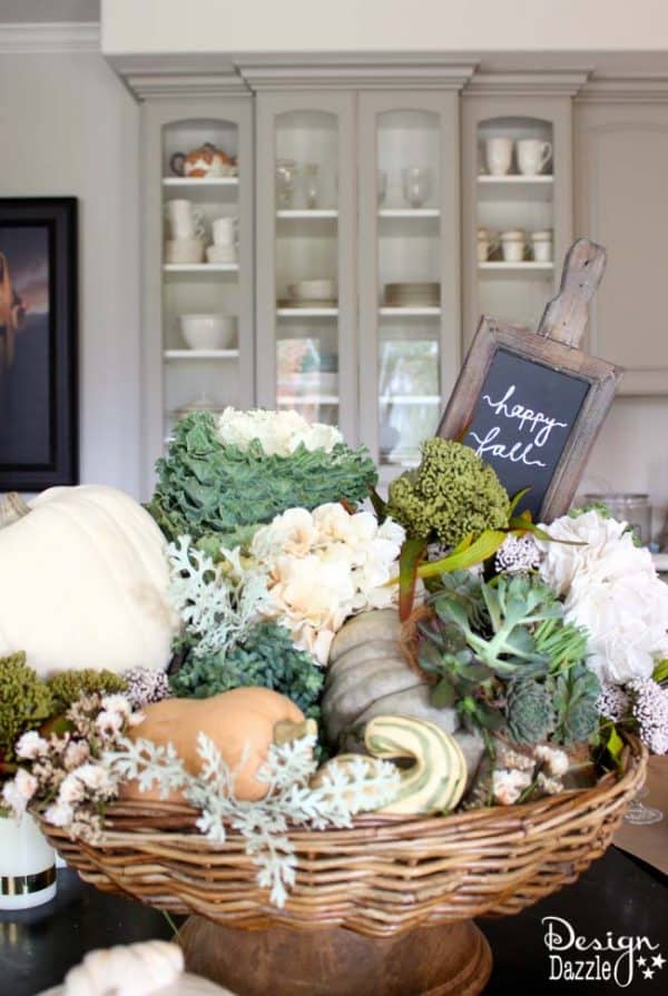 Succulents, ornamental cabbages, winter squash used with neutrals and a touch of glitz to create a stunning Thanksgiving tablescape. || thanksgiving decor | tablescape ideas for thanksgiving | decorating for fall | fall table decor | thanksgiving table decor || Design Dazzle #thanksgivingdecor #falltablescape #falltabledecor