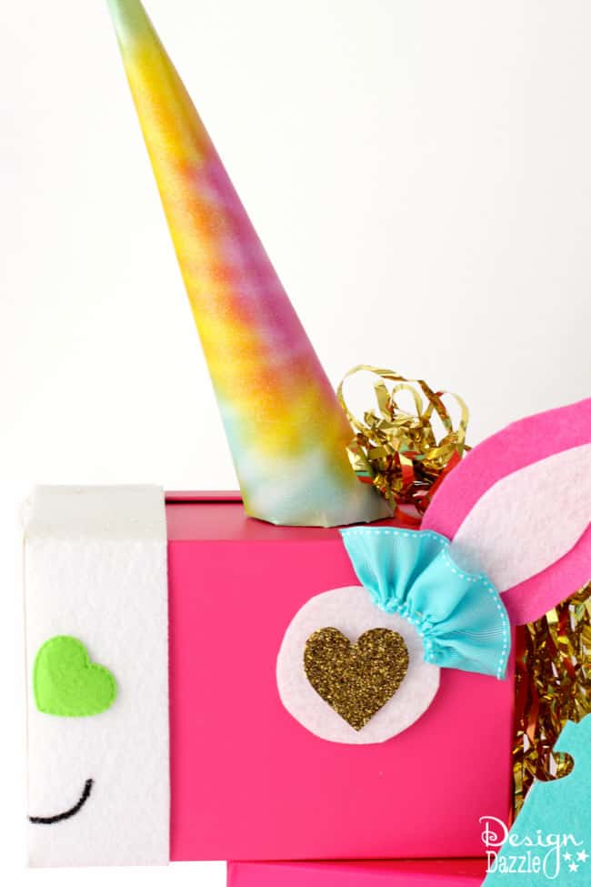 This Unicorn Valentine Card Box DIY project is a fun whimsical twist on a classic valentines card holder! This Unicorn just makes me smile! Step by Step instructions on Design Dazzle. 