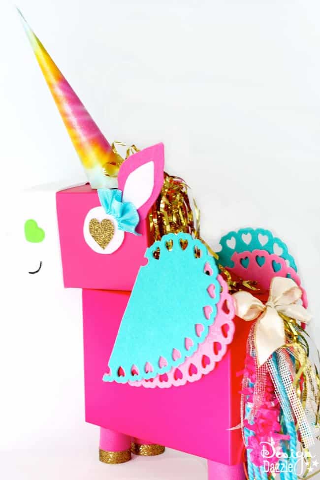 This Unicorn Valentine Card Box DIY project is a fun whimsical twist on a classic valentines card holder! This Unicorn just makes me smile! Step by Step instructions on Design Dazzle. 