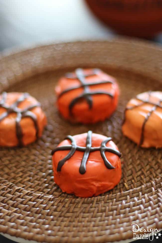 Easy Basketball Snack Cakes Made With Ding Dongs. Cute party idea for a absketball party or March Madness theme. Enjoy making with your family! Design Dazzle