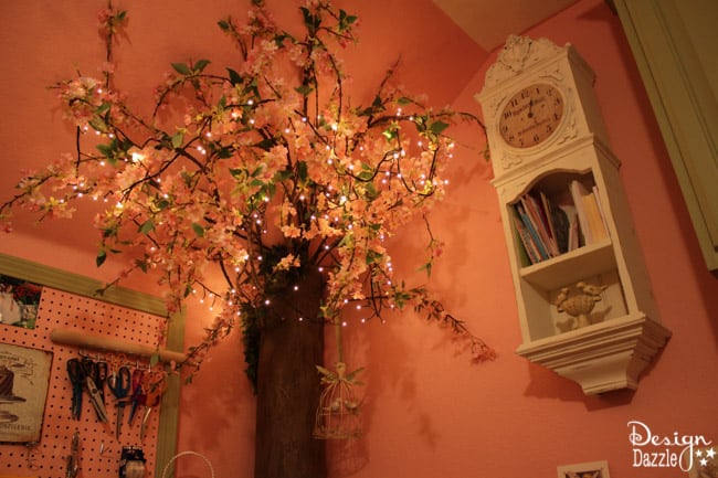 Craft room created using old kitchen cabinets. The tree with the blossom added just the right touch to my craft room. I loved turning on the fairy lights and crafting in there! Design Dazzle