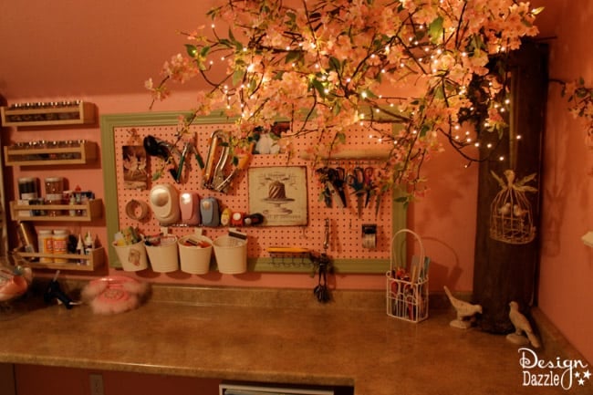 Craft room created using old kitchen cabinets. The tree with the blossom added just the right touch to my craft room. I loved turning on the fairy lights and crafting in there! Design Dazzle