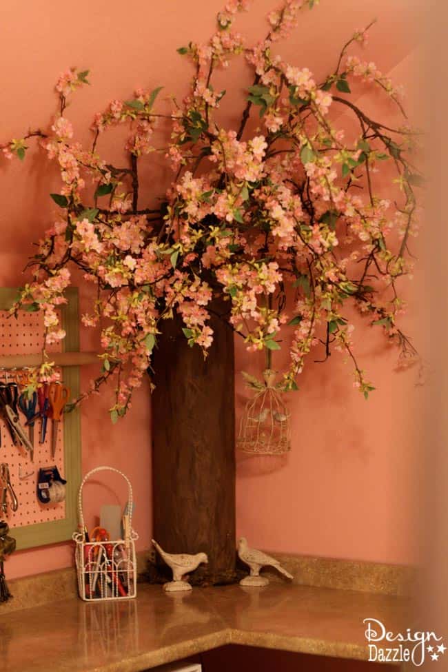 Craft room created using old kitchen cabinets. The tree with the blossom added just the right touch to my craft room. I loved turning on the fairy lights and crafting in there! Design Dazzle