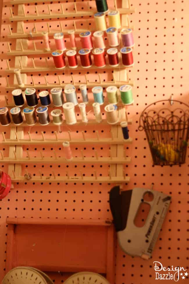 Craft room created using old kitchen cabinets. The tree with the blossom added just the right touch to my craft room. I loved turning on the fairy lights and crafting in there! Pegboards really help organize lots of craft products. Design Dazzle