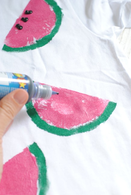 adding puffy paint for watermelon seeds