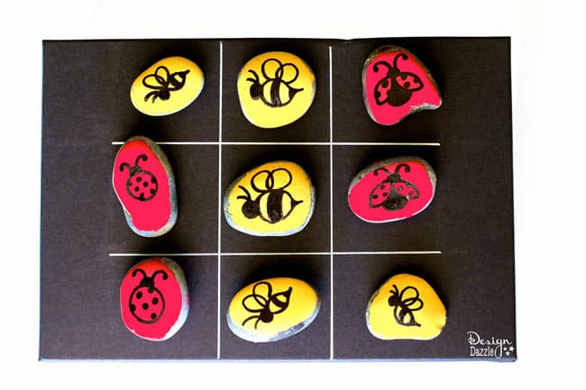 Tic Tac Toe Stones Game Box will keep the kids entertained! Paint your own stones and create your very own Tic Tac Toe game. | Design Dazzle