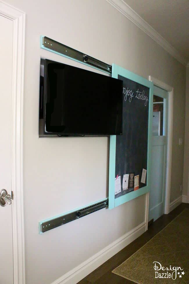 The kitchen TV is hidden in the wall and the chalkboard slides to cover! | Design Dazzle