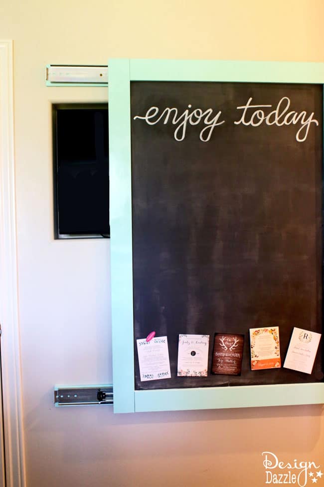 This magnetic chalkboard slides to reveal the hidden kitchen TV. | Design Dazzle