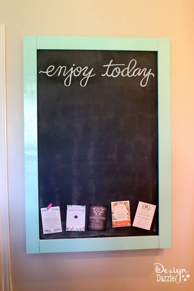 This magnetic chalkboard slides to reveal the hidden kitchen TV. | Design Dazzle