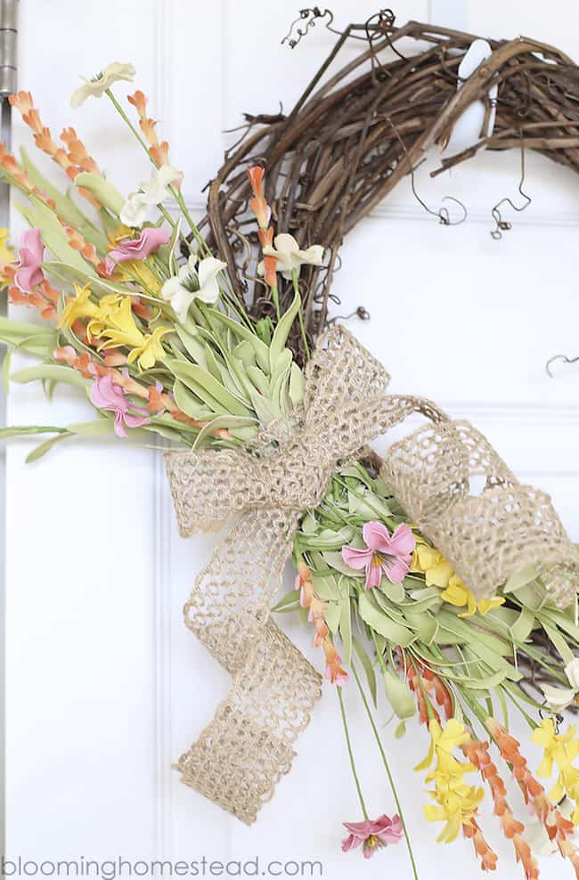 All 13 of these spectacular spring wreaths are simple to create, fun, creative, and will leave you with a gorgeous looking front door! | Design Dazzle