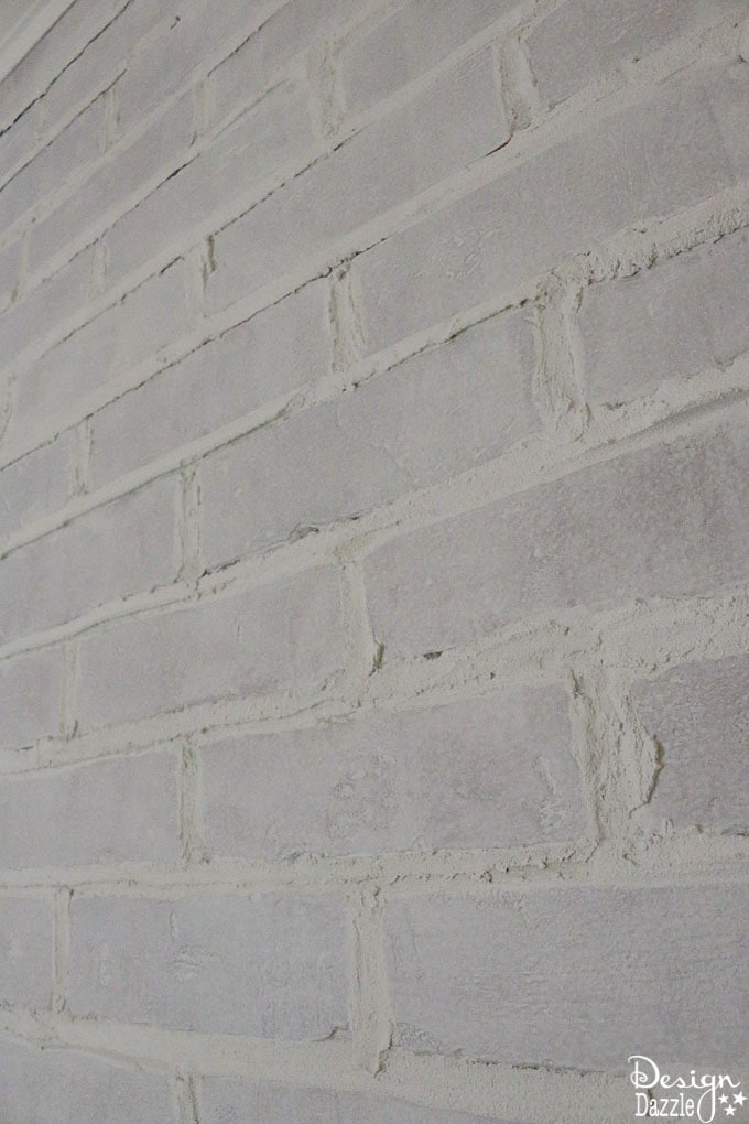 This post shows how to take fake brick wall paneling and turn it into a real looking, white washed brick wall! The perfect solution if you're on a budget. | Design Dazzle