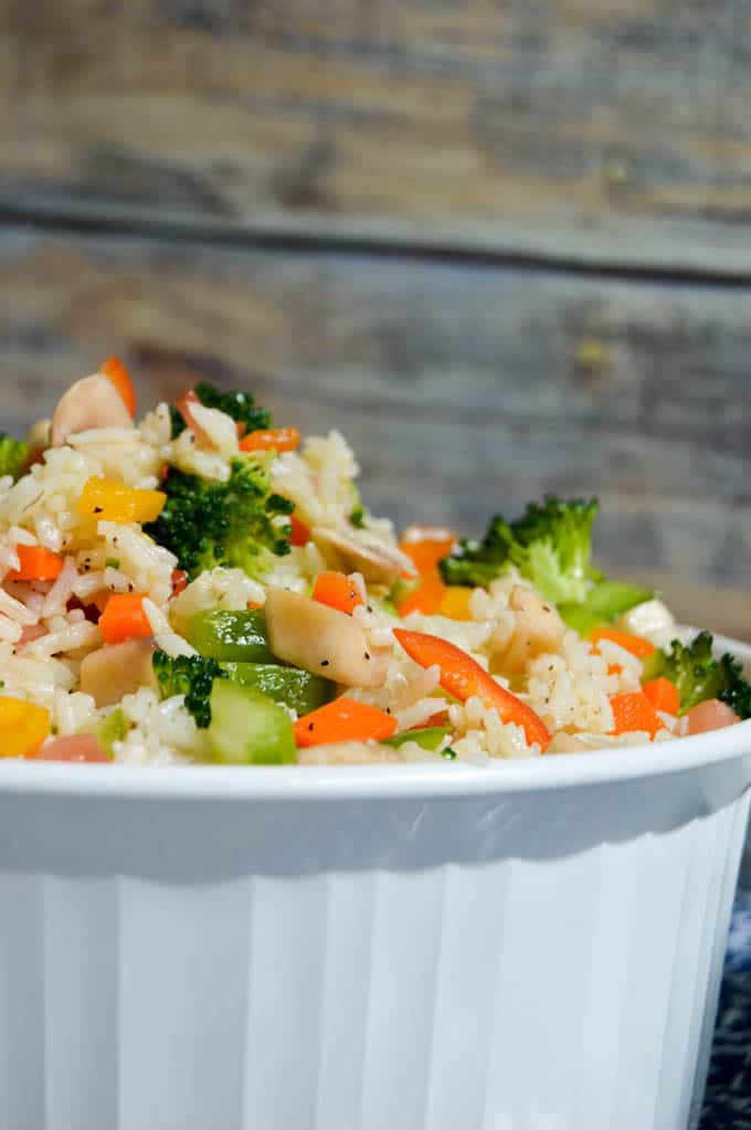 This Garden Veggie Rice Salad is not only healthy and delicious but also leaves you feeling full and satisfied afterwards. It's so quick to put together! | healthy rice recipes | healthy vegetable recipes | simple dinner recipes | quick dinner recipes | healthy dinner recipes | how to use garden vegetables | garden vegetable recipes || Design Dazzle #healthyrecipes