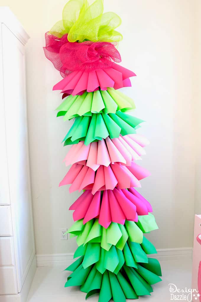 Design Dazzle shows you how to make a paper cone Christmas tree for the perfect Grinch party. Grinch Paper Cone Christmas Tree | grinch holiday decorations | grinch party decor | grinch inspired holiday party | diy grinch decor || Design Dazzle #grinchtree #grinchdecor #grinchparty