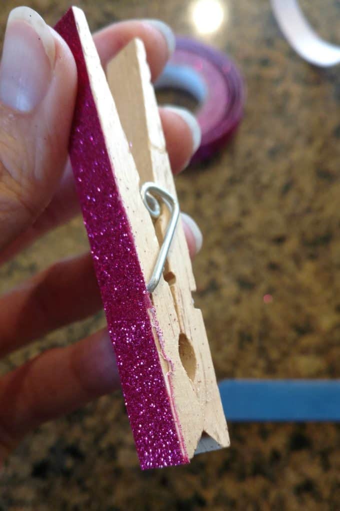 Add a little glam and glitter to some plain clothespins with washi tape then glue on a magnet for a simple DIY project that is both fun and practical!