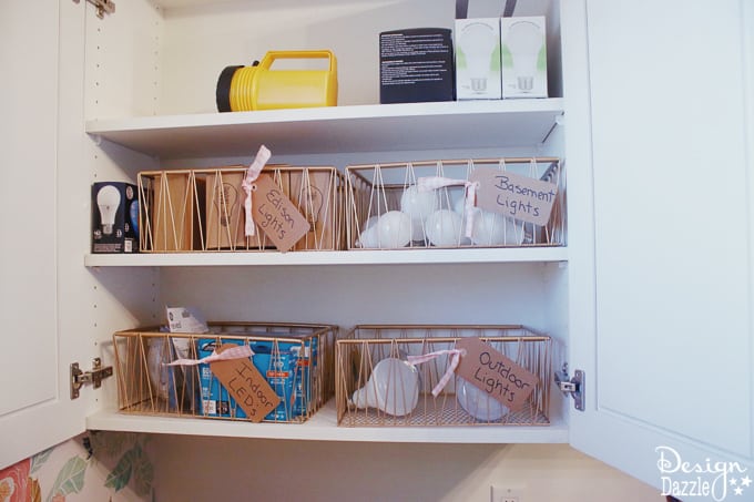 I'm showing you how to take your laundry room cabinet organization from drab to fab while on a budget! You will love these rose gold metal baskets! | Design Dazzle