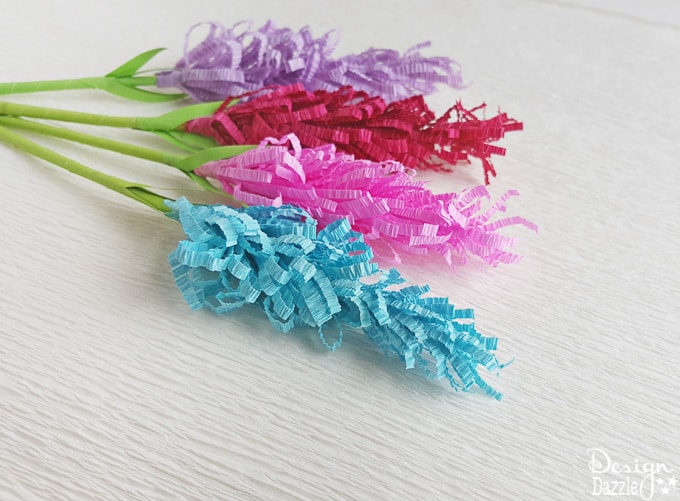 If you are looking for an extremely fun craft to do with the kiddos or even a gorgeous addition to your home or party decor, these lavender paper flowers would be perfect! This post even includes a free template! | Design Dazzle