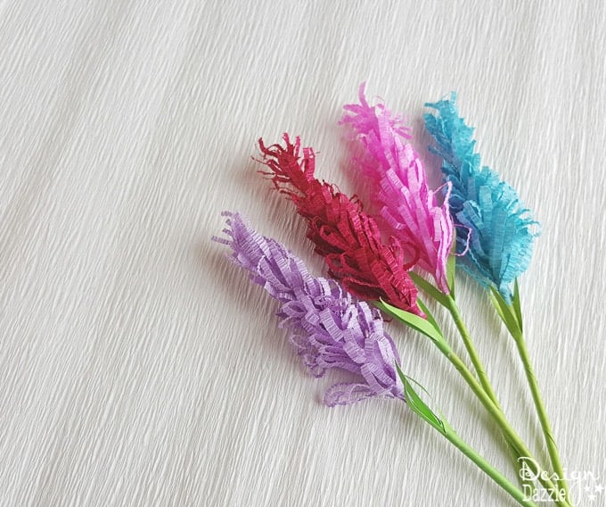 If you are looking for an extremely fun craft to do with the kiddos or even a gorgeous addition to your home or party decor, these lavender paper flowers would be perfect! This post even includes a free template! | Design Dazzle