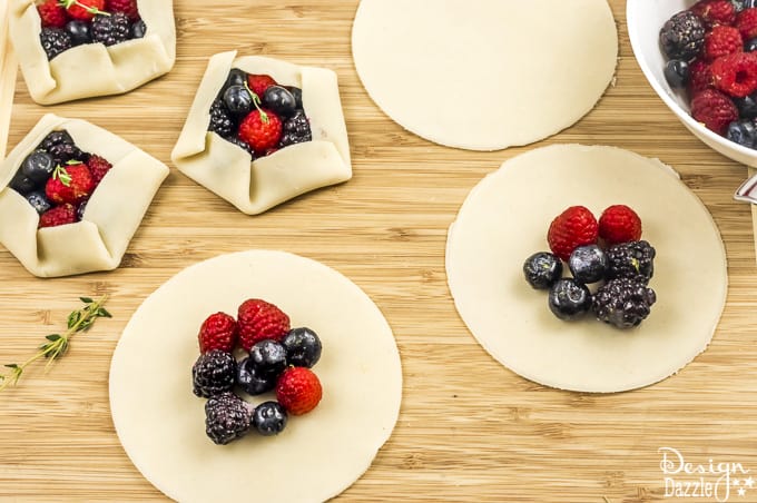 Not only are these Mini Mixed Berry Galettes absolutely delicious but they are gorgeous too! Perfect for a wedding shower, spring party, or even a summer barbecue! | Design Dazzle