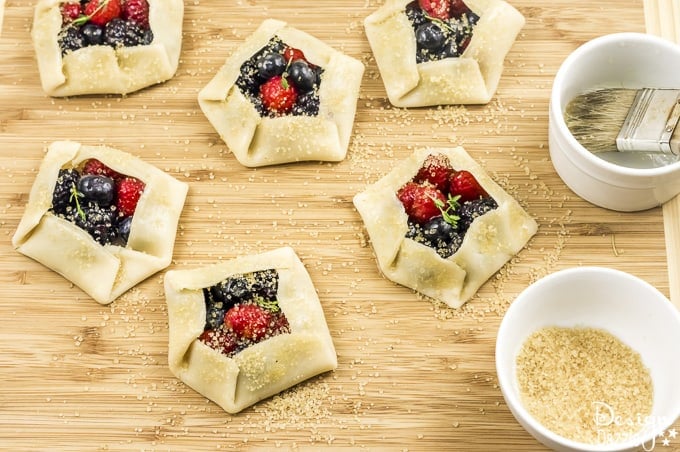 Not only are these Mini Mixed Berry Galettes absolutely delicious but they are gorgeous too! Perfect for a wedding shower, spring party, or even a summer barbecue! | Design Dazzle