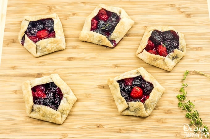 Not only are these Mini Mixed Berry Galettes absolutely delicious but they are gorgeous too! Perfect for a wedding shower, spring party, or even a summer barbecue! | Design Dazzle