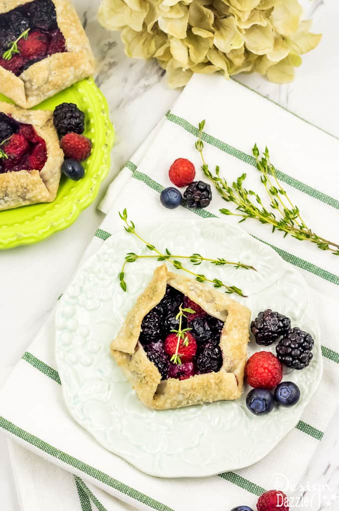 Not only are these Mini Mixed Berry Galettes absolutely delicious but they are gorgeous too! Perfect for a wedding shower, spring party, or even a summer barbecue! | Design Dazzle