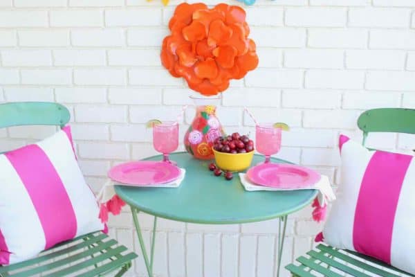 Front Porch Summer Decor. Beautiful hues of pink, yellow, orange, and more make for a colorful and happy porch | Design Dazzle