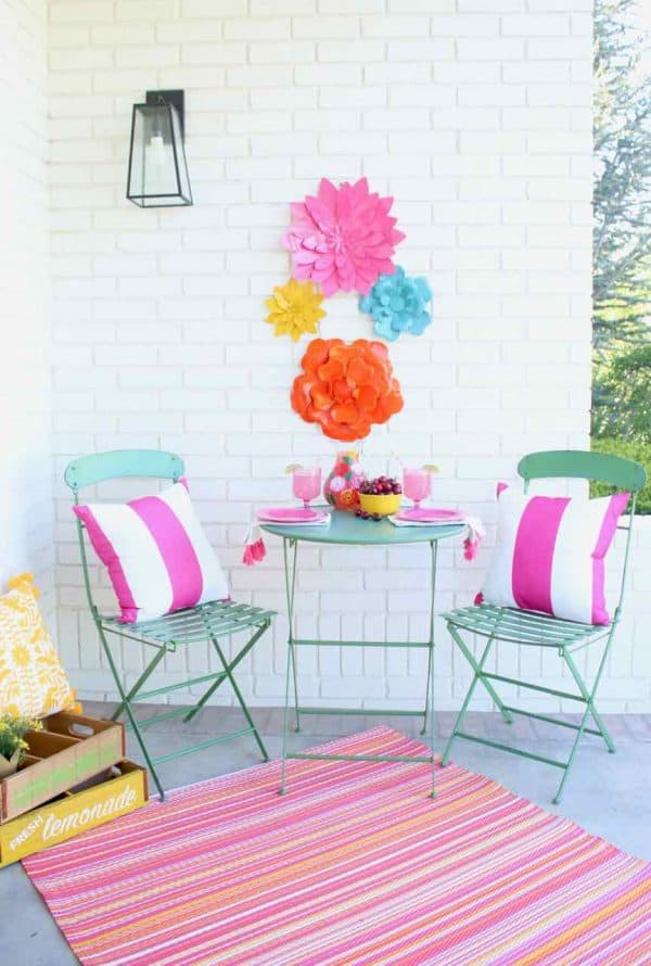 Front Porch Summer Decor. Beautiful hues of pink, yellow, orange, and more make for a colorful and happy porch | Design Dazzle